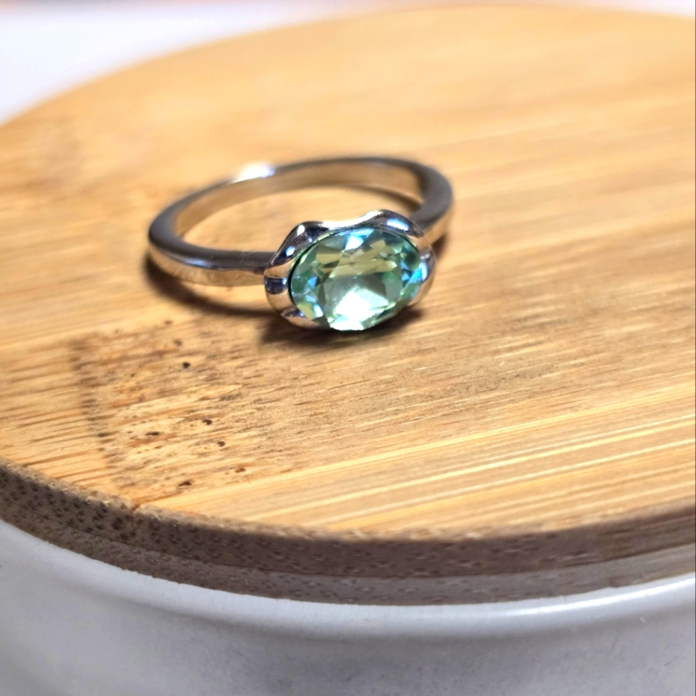 Womens size 6.5 ring. Silver setting.  Peridot color cz .